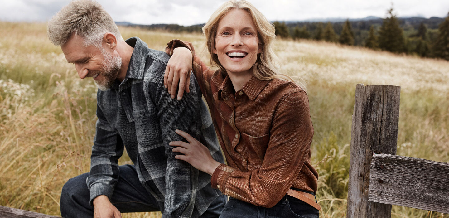 Man and Woman sitting outside in a field