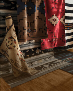 Stacked and rolled rugs showing patterns