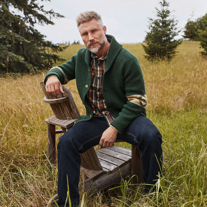 Man sitting outside wearing a Cardigan Sweater