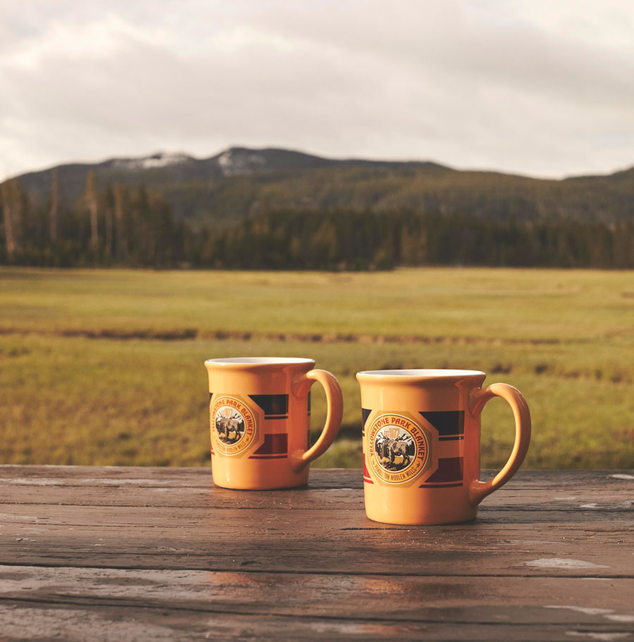 Pendleton Yellowstone Park mugs on a picnic table in Yellowstone National Park.