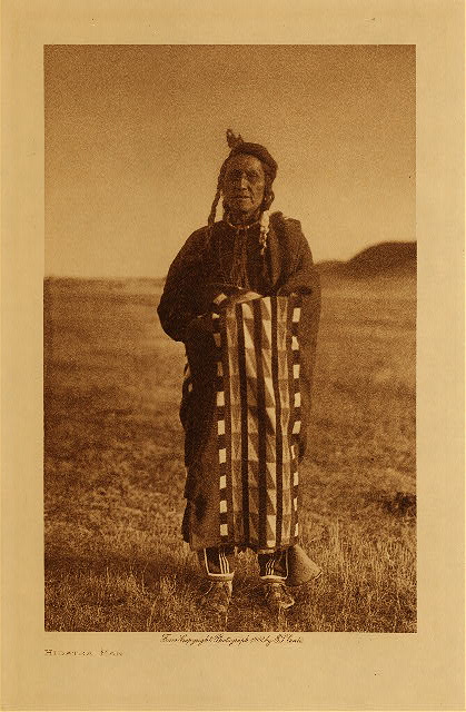 Hidatsa man by Edward Curtis. A Hidatsa man wrapped in one of the Racine blankets.