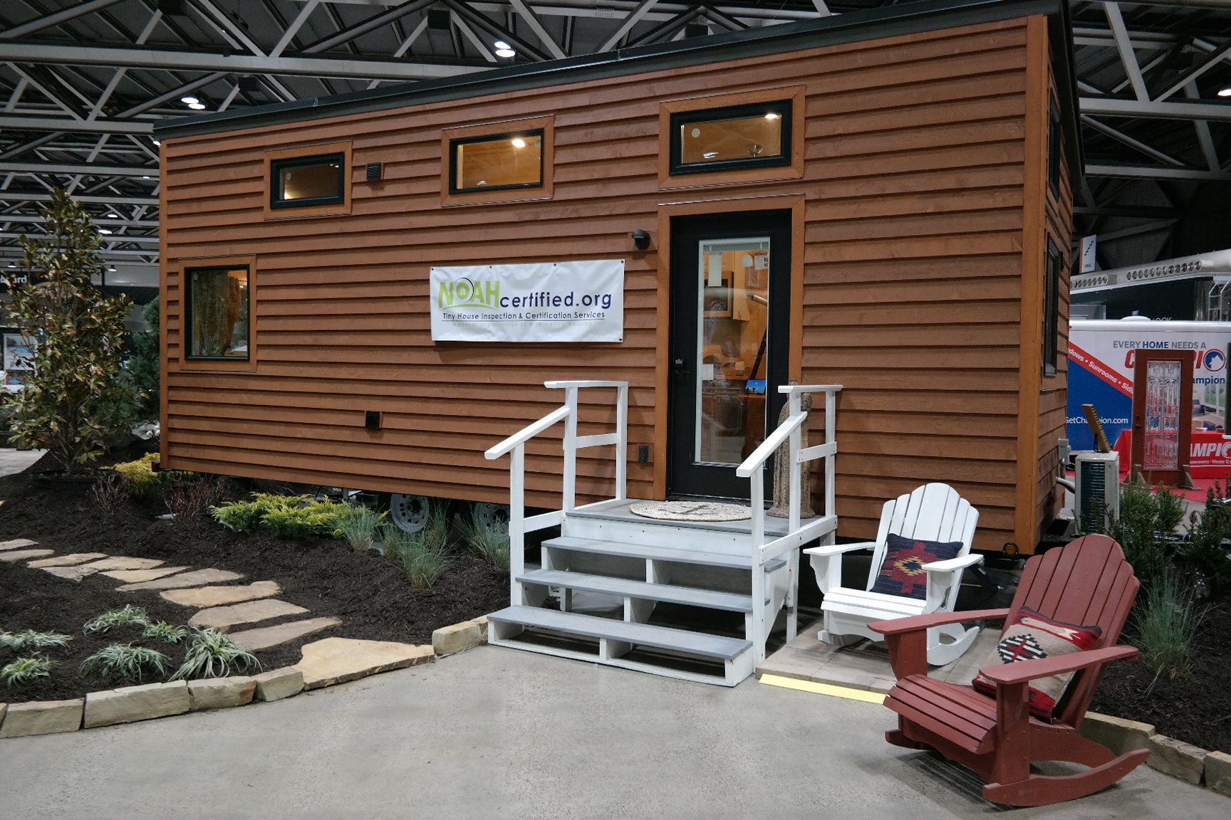 The exterior of the tiny home, which is parked inside the auditorium. 