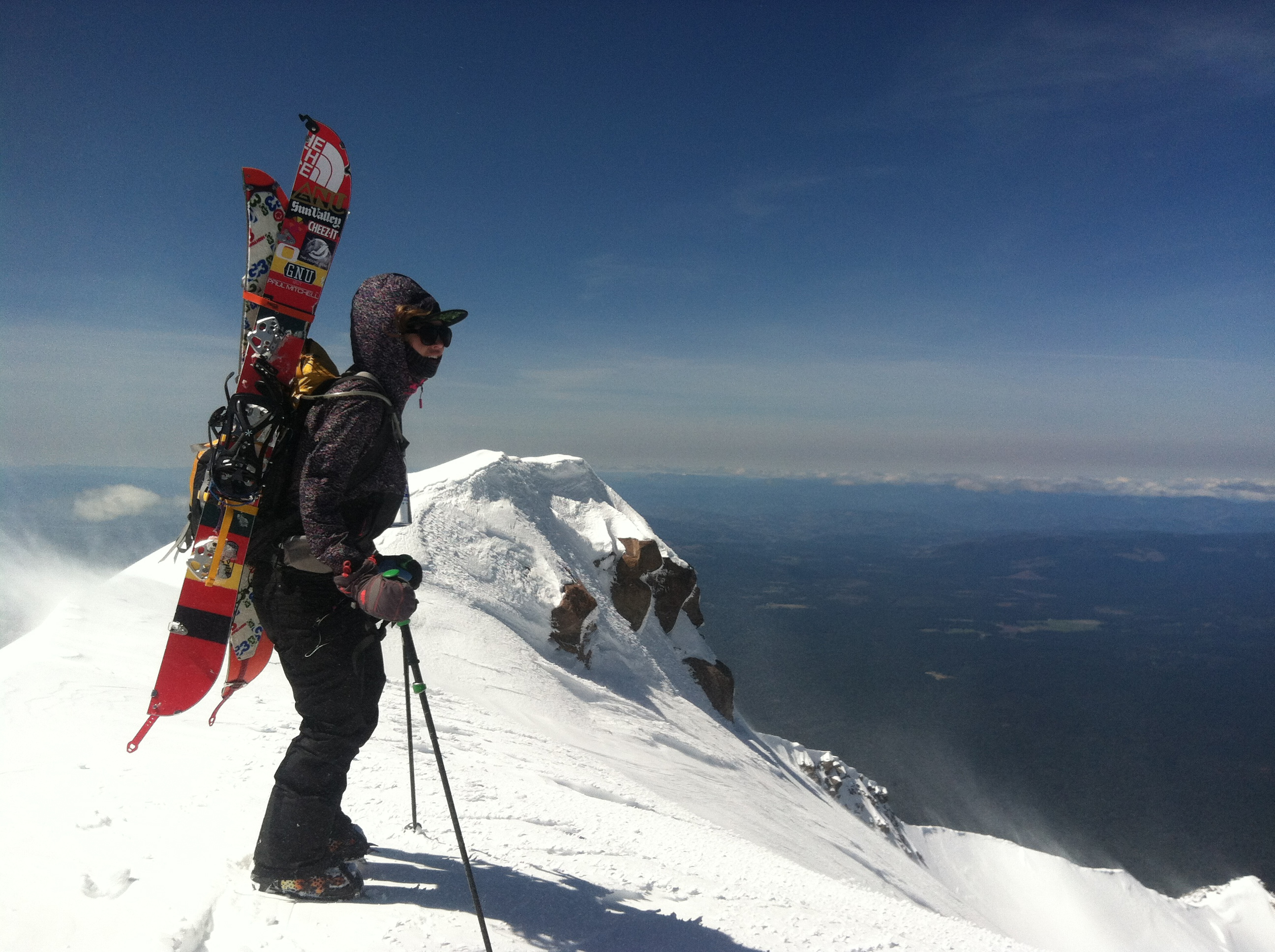 A professional women's snowboarder at the peak of Mount Rainier. 