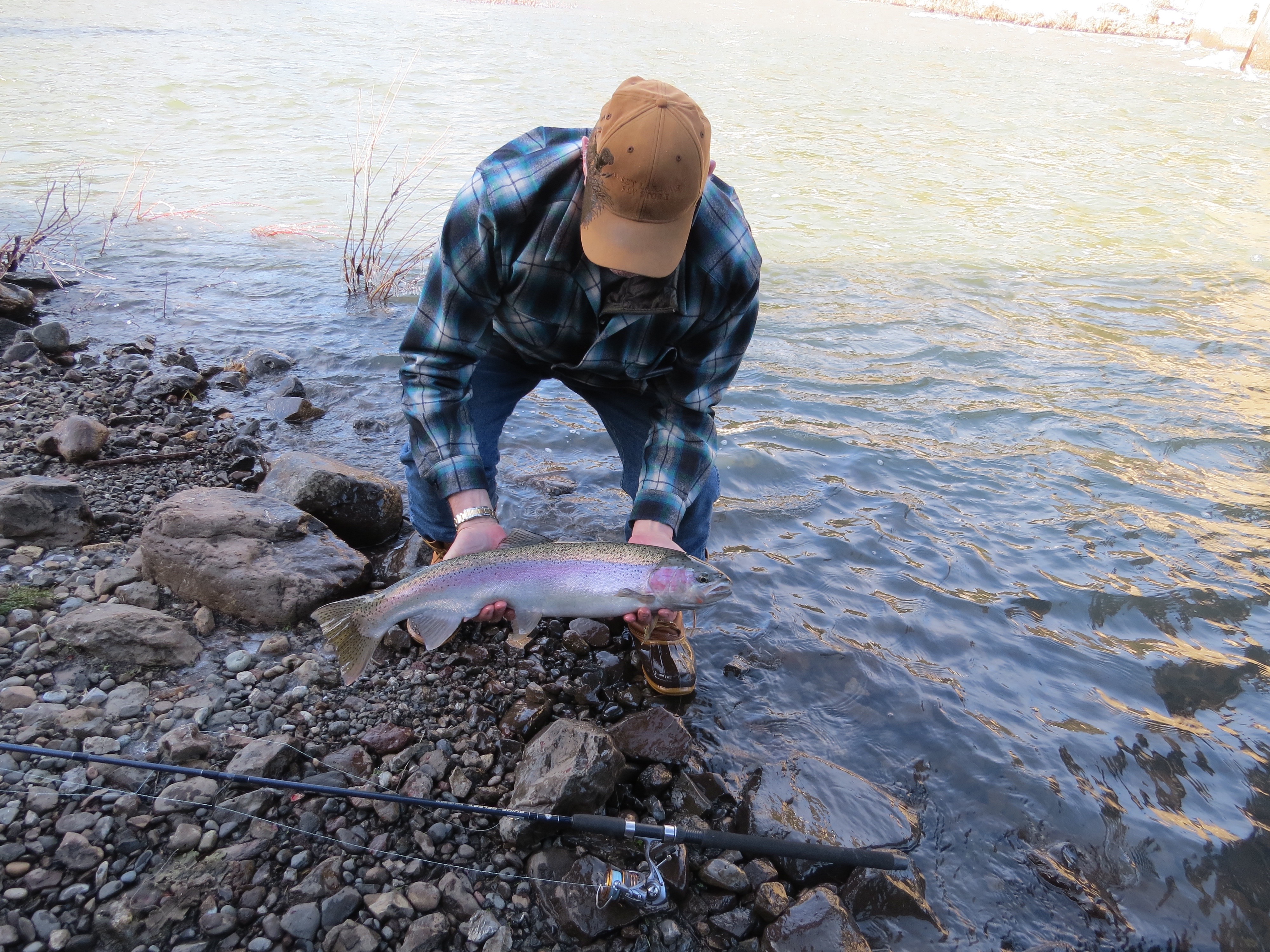 Catch of the day; a nice trout displayed by a fisherman. 