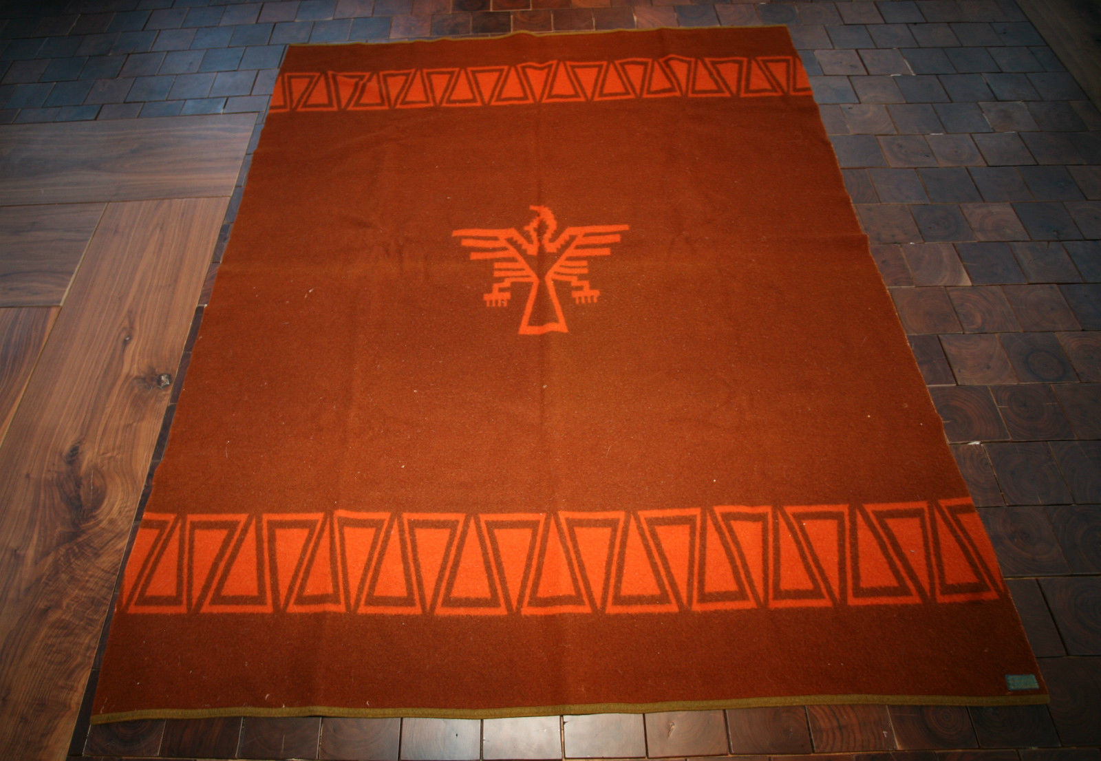 The 1929 version of the Zion Park blanket, a thunderbird on a rust red background.