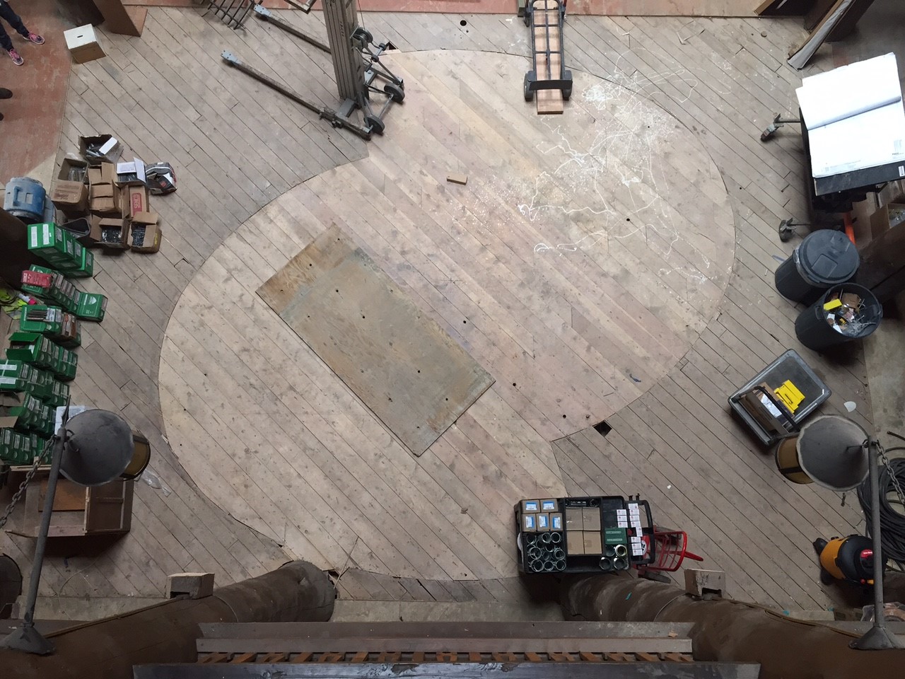 A shot from the interior balcony of the Many Glacier Hotel mezzanine, showing the original footprint of the Helical Stairs on the wooden floor.