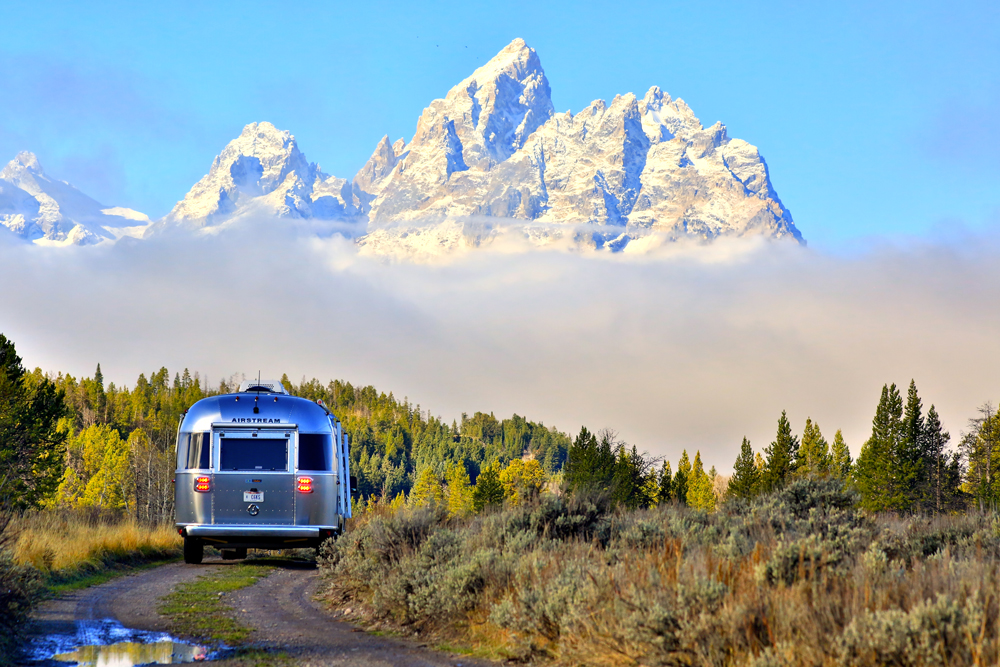 The rear of the Pendleton Airstream as it drives along a mountain road