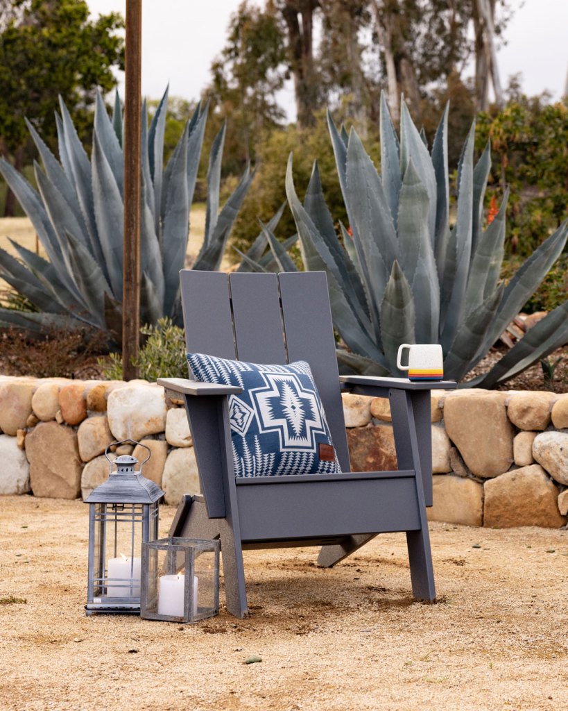 An Adirondack chair with a Pendleton and Yardbird pillow in the Harding pattern. 