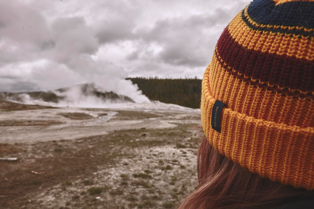 OurFreeWays_A girl in a hat surveys the geyesers of Yellowstone