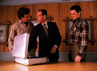 Sheriff and Agent Cooper in their offices.