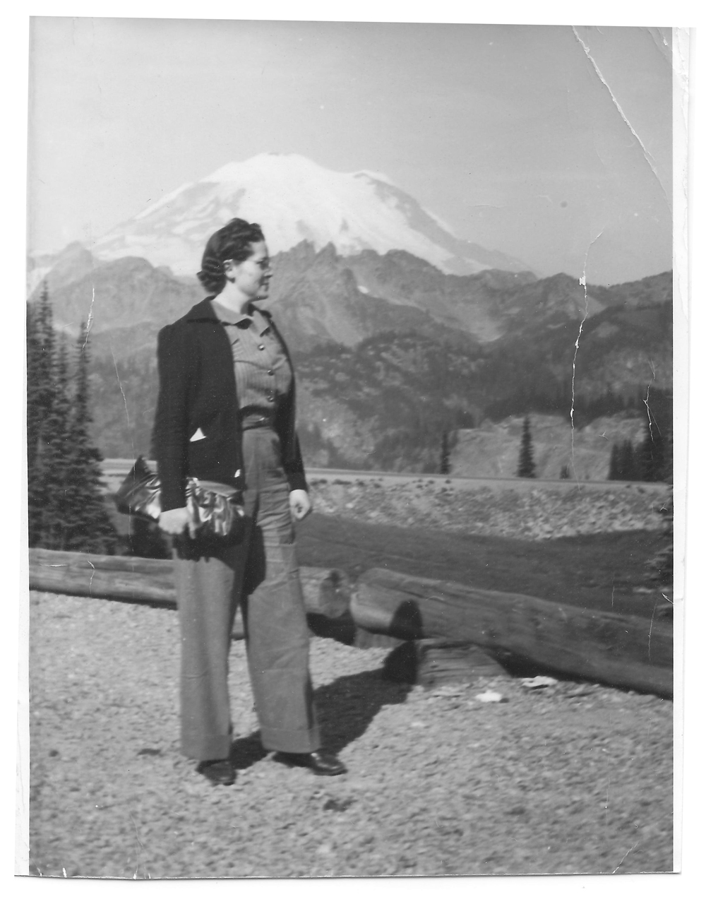 A vintage photo of Louise Kelly standing in front of Mt. Rainier.