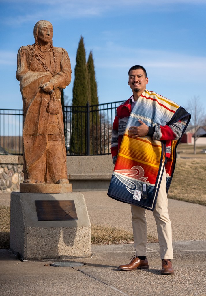 Trey Blackhwawk poses with his award-winning blanket