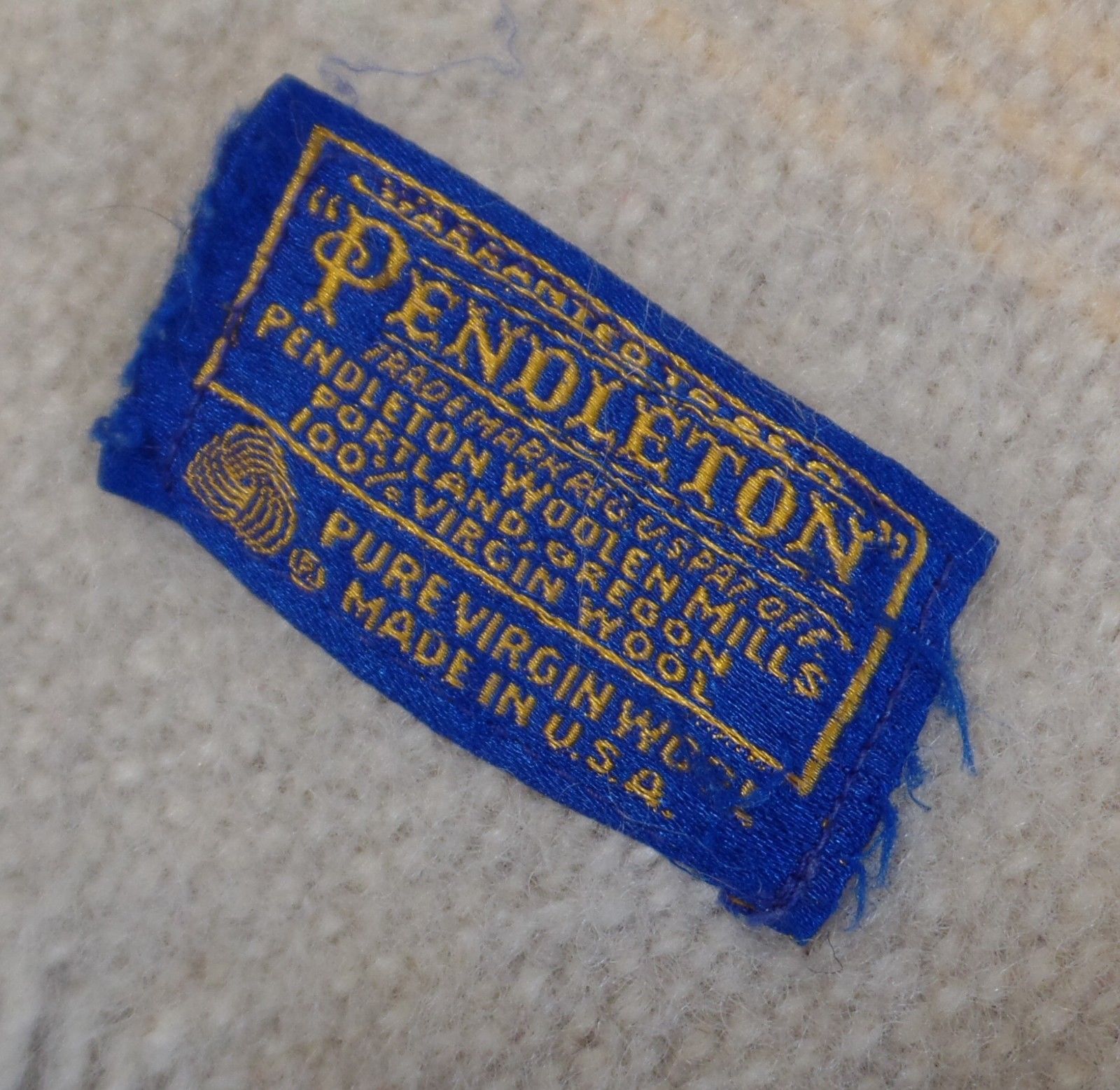 A closeup of the Pendleton blue and gold embroidered label on the 1960s Zion National Park throw.