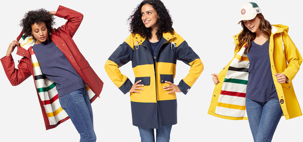 Three women pose in the studio, wearing Pendleton rain slickers.