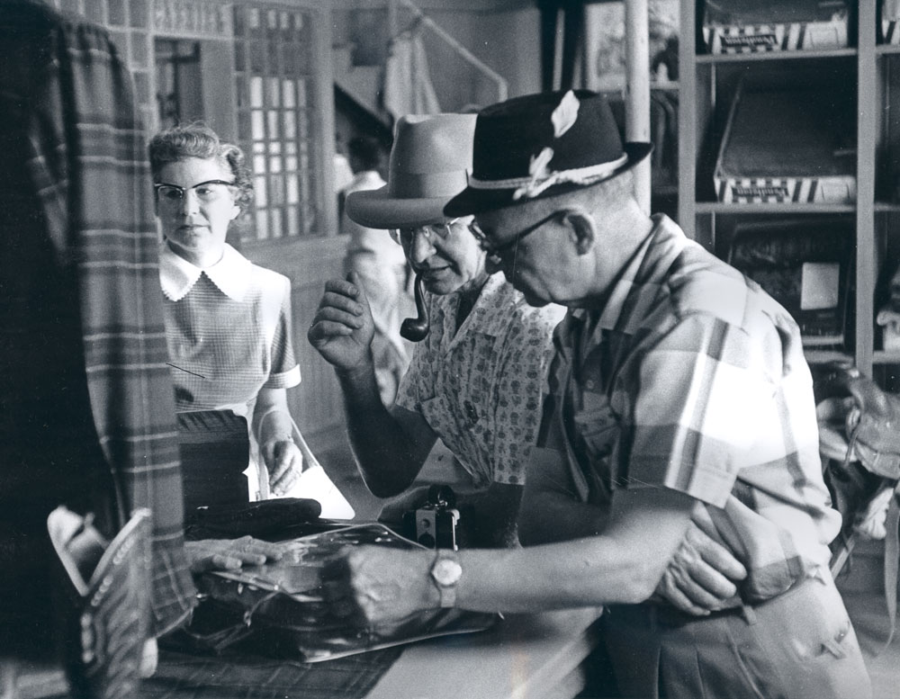 A photo from the Pendleton archives of the Pendleton store in Disneyland: A woman and two gentlemen shopping.