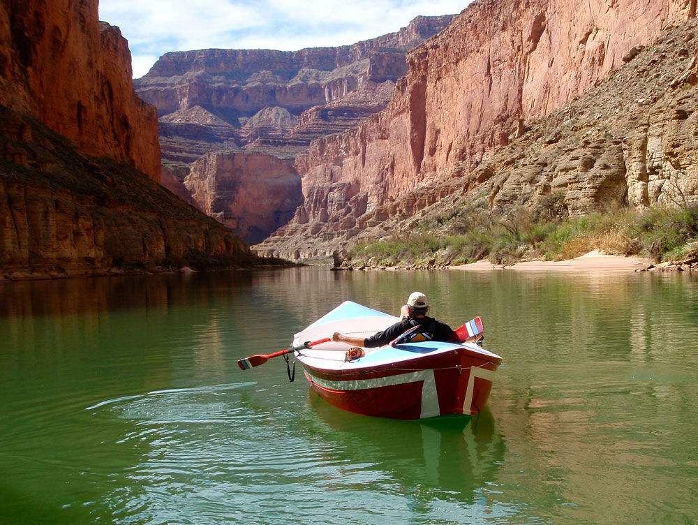 Greg Hatten in the Portola, on still green waters of the Colorado River.