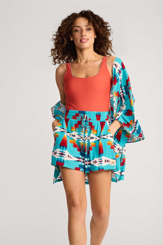 Woman wearing shorts and a kimono top over a reversible Pendleton tank suit from Pendleton Swim.