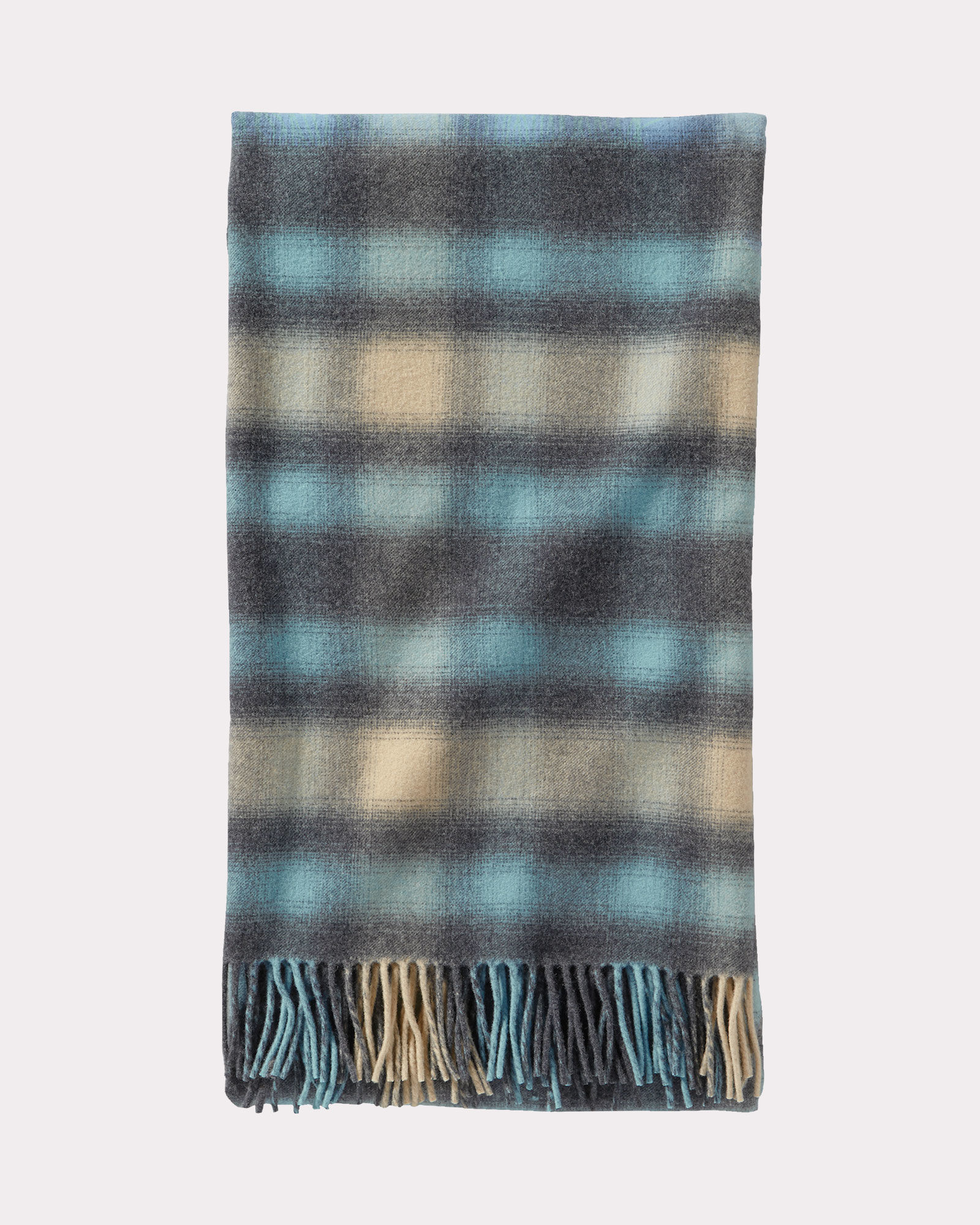 A folded Pendleton 5th Avenue throw in a soft blue plaid.