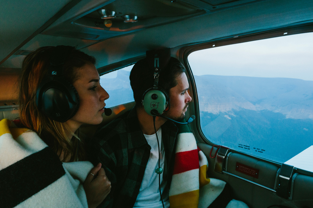 Irey_A man and woman look out the window of a small plane