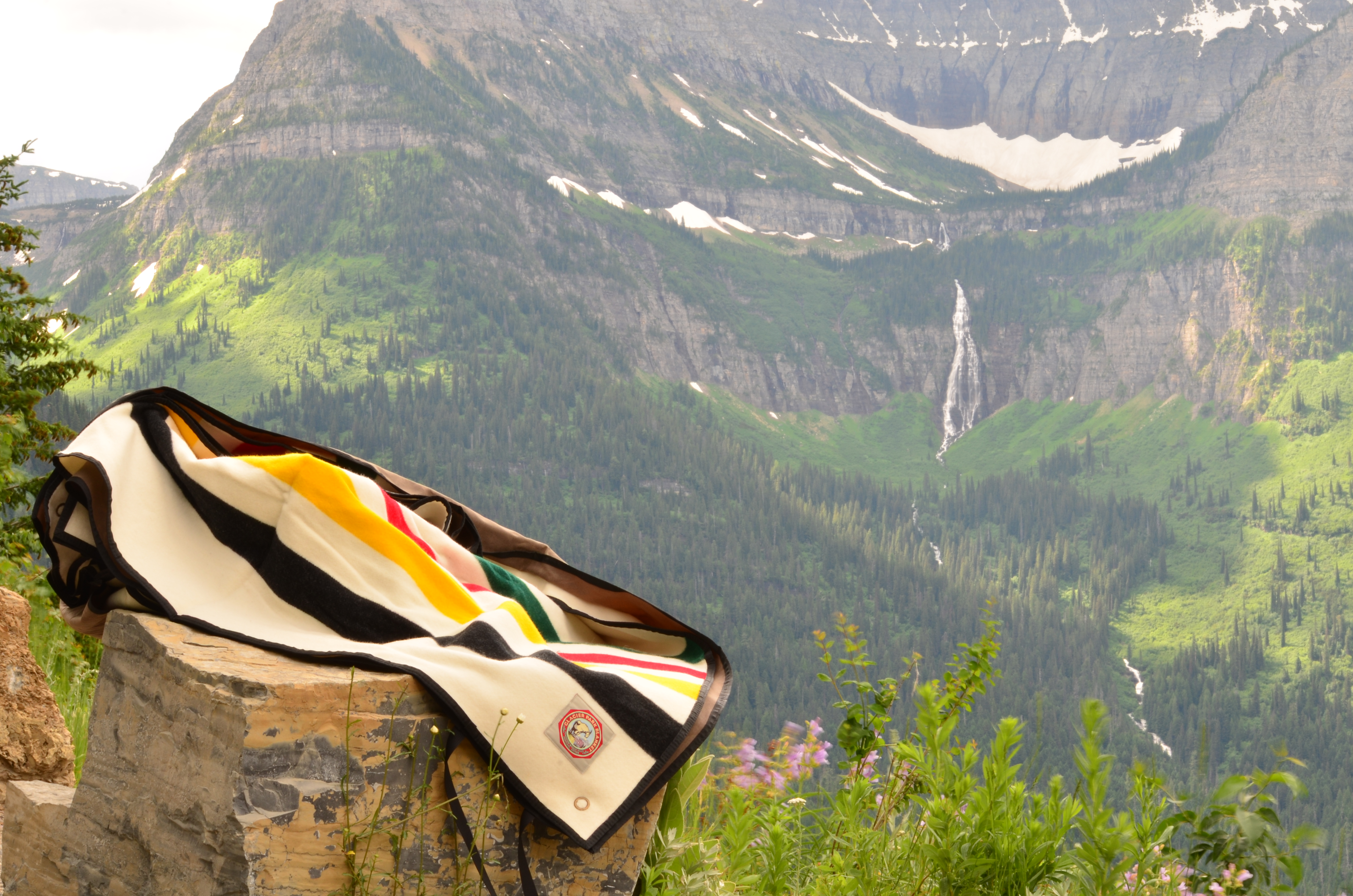 Glacier Park ROll-up blanket on rocks at Road To The Sun in Glacier National Park. 