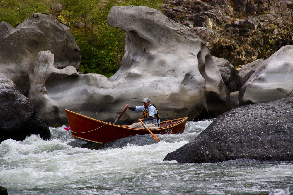 Greg Hatten steers his wooden drift boat through the rapids on the Rogue River.