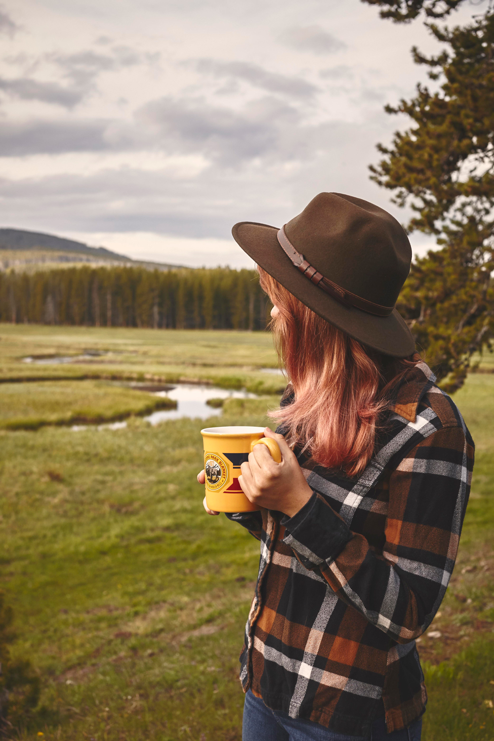 OurFreeWays_ A girl wearing a hat drinks from a pendleton Yellowstone mug