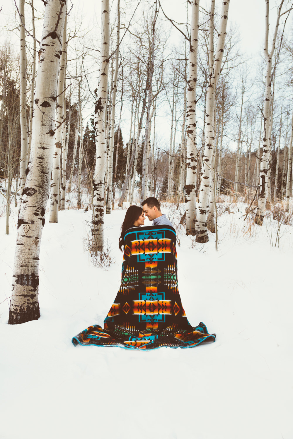 A man and woman wrapped in a Chief Josephblanket