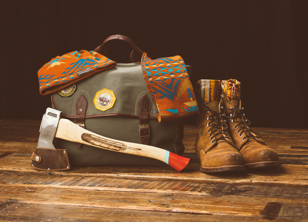 Brandon-Burk-Photography: a still live of a bag, axe, boots, scarf and beanie. 