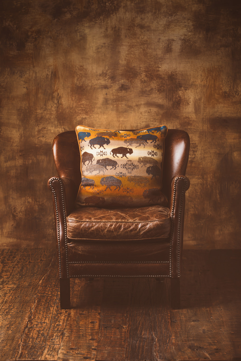 A leather chair and a buffalo wool pillow