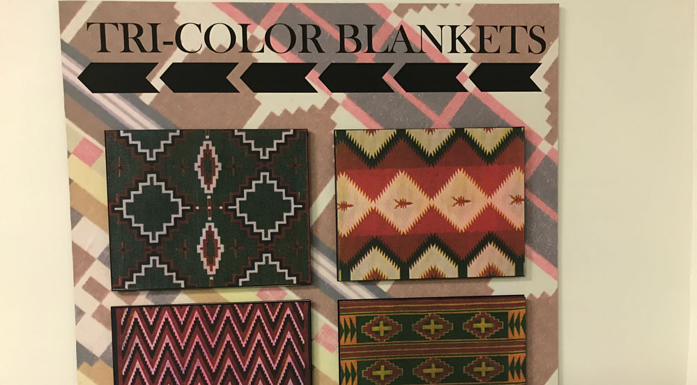 A poster on the wall showing wool "tricolor blankets" at the St. Joseph museum.