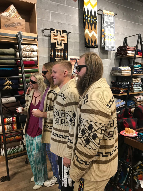 Four people in Big Lebowski sweaters