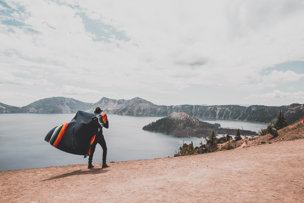 Kyle Houck - A man with a Crater Lake blanket slung over his shoulders walks near Oregon's Crater lake. 