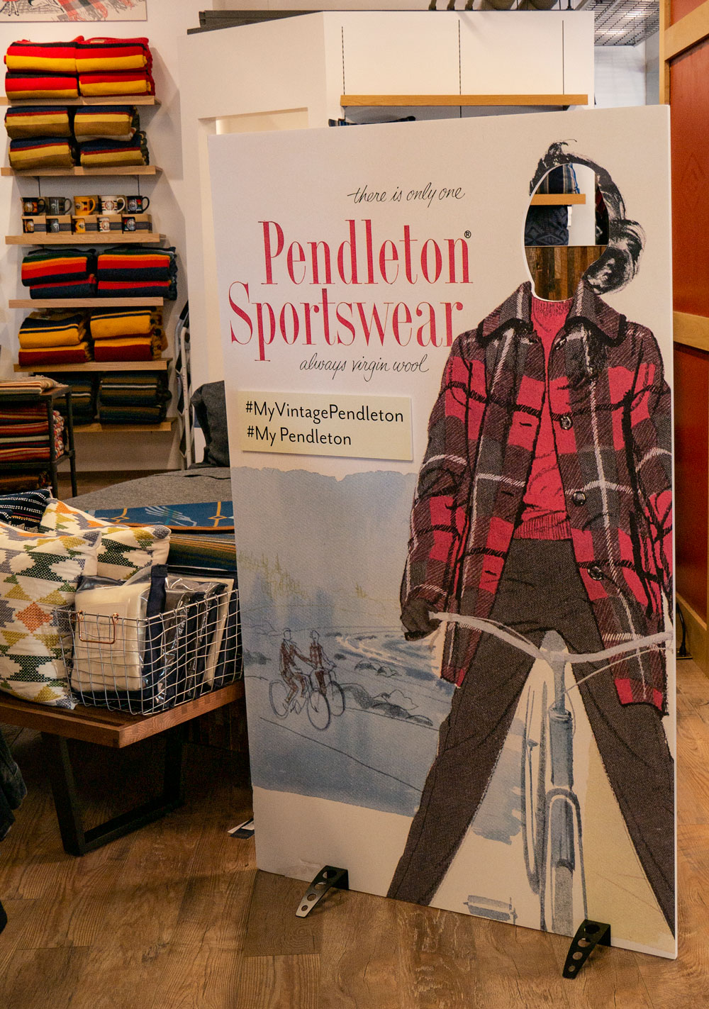 vintage pendleton ad of woman on bicycle placard with hole in face area where customers can put their own faces