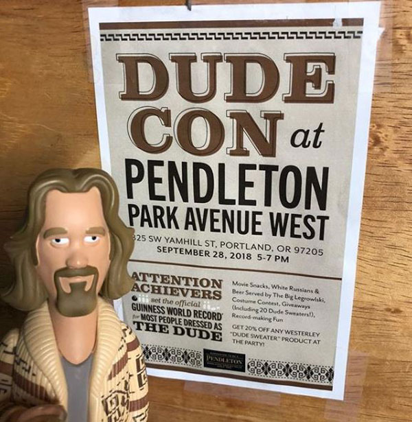 A "Dude" figurine and sign for #DudeCon