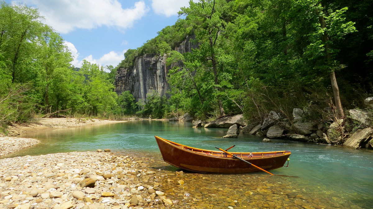 Greh Hatten's wooden boat waiting on the banks of the Buffalo National River