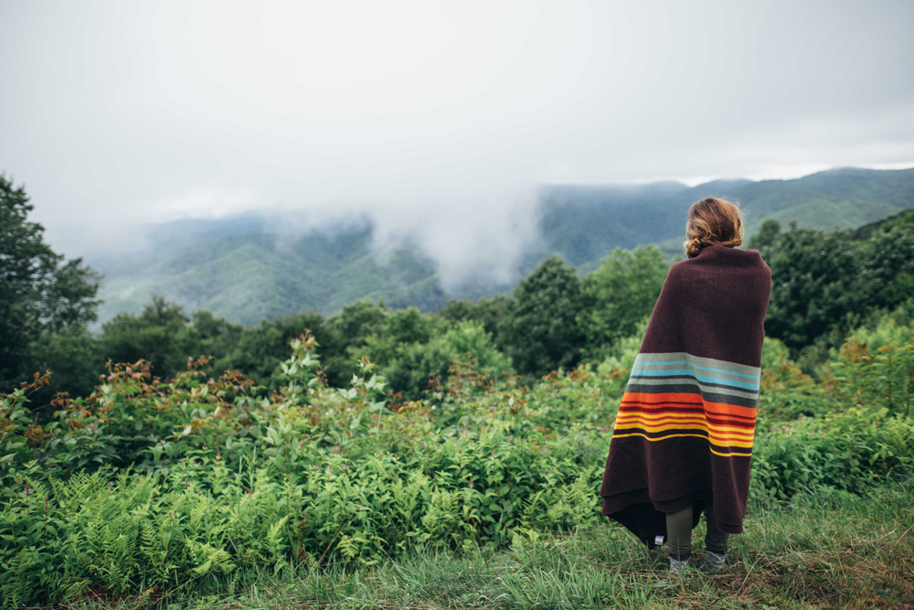 Matthews_ A woman wrapped in a blanket looks out at the park