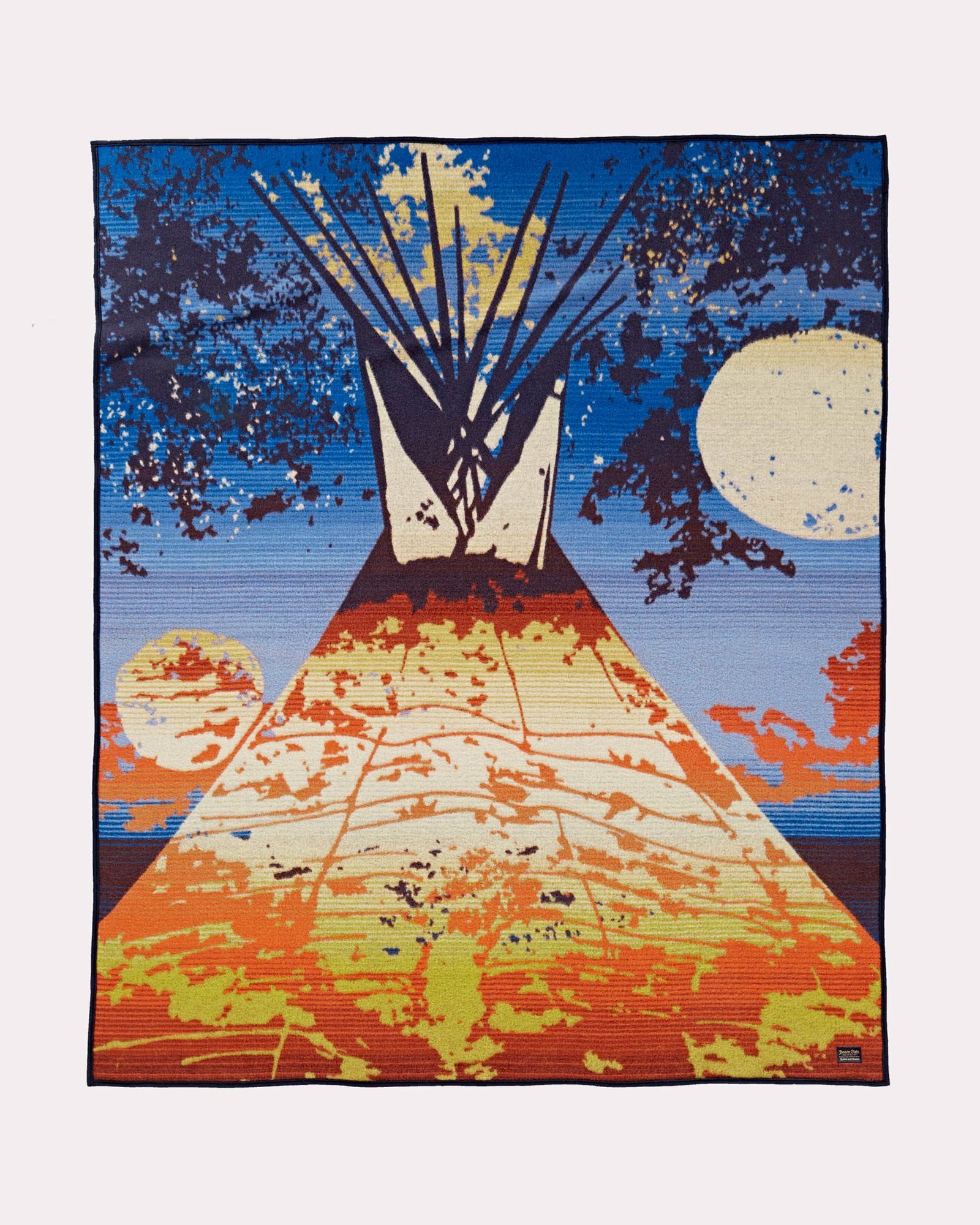 The Full Moon Lodge blanket by pendleton shows a bright orange and gold teepee against a dark blue sky, wit a full moon shining through tree branches. This blanket was designed by artist Starr Hardridge.