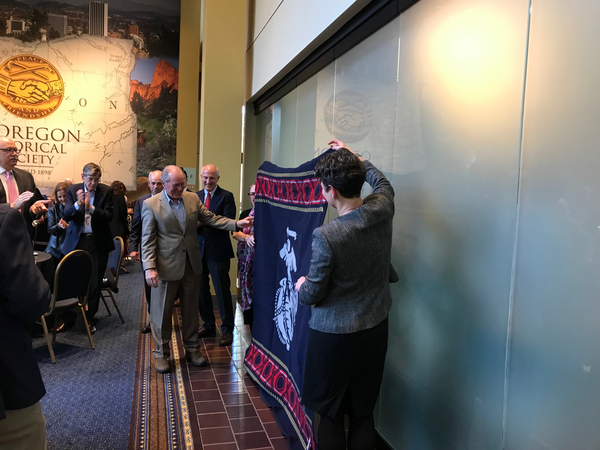 Former Oregon Governor Ted Kulongoski receiving a Pendleton Marines blanket at the Oregon Historical Society