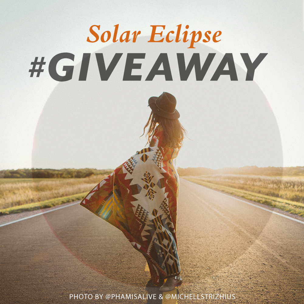 A young woman wrapped in a Journey West blanket stares at the horizon, with the words "Solar Eclipse Giveaway"