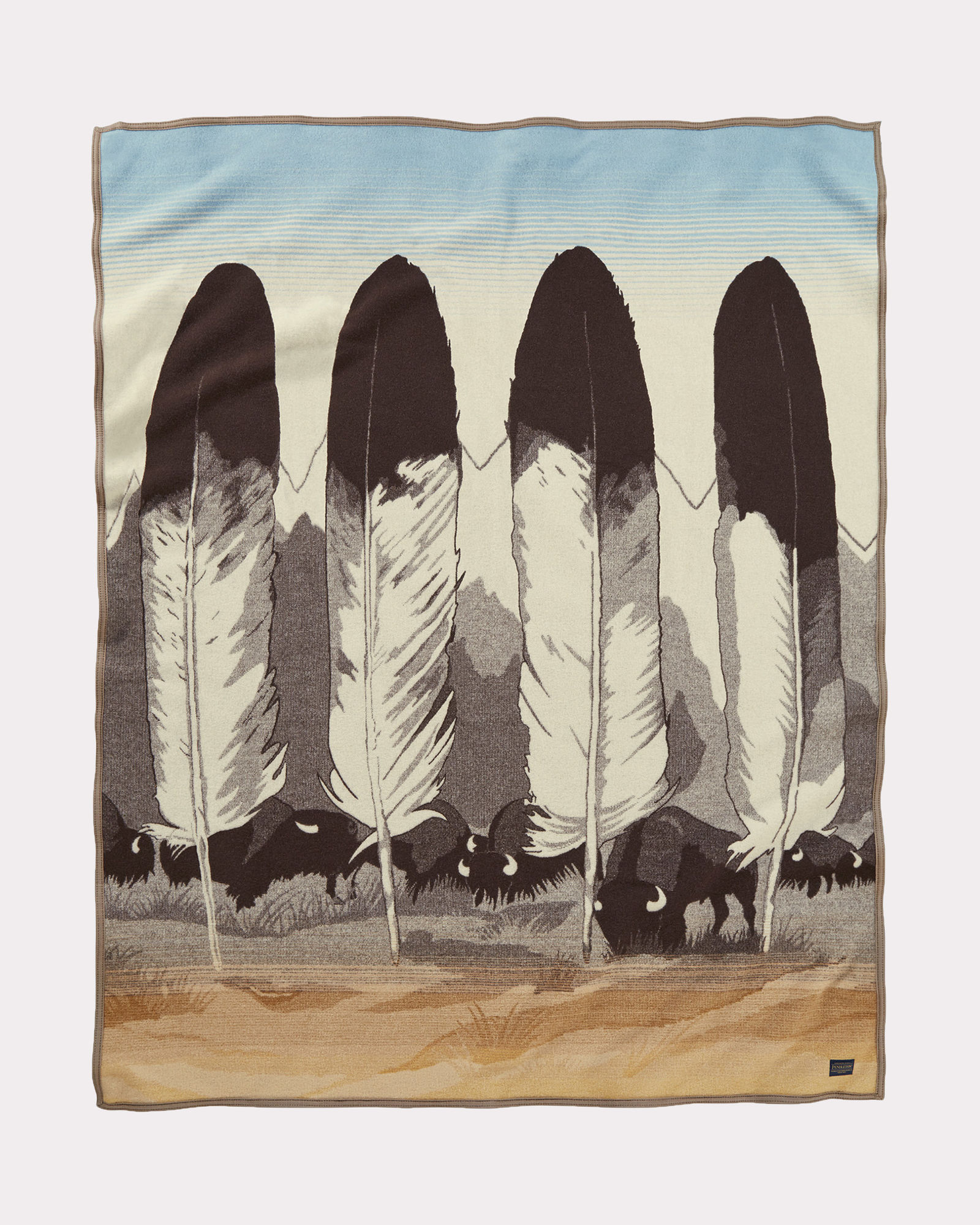 Pendleton Legendary Series blanket, "In Their Element" designed by artist Joe Toledo. The blanket design contains four eagle feather, a mountain range, and a herd of grazing buffalo.