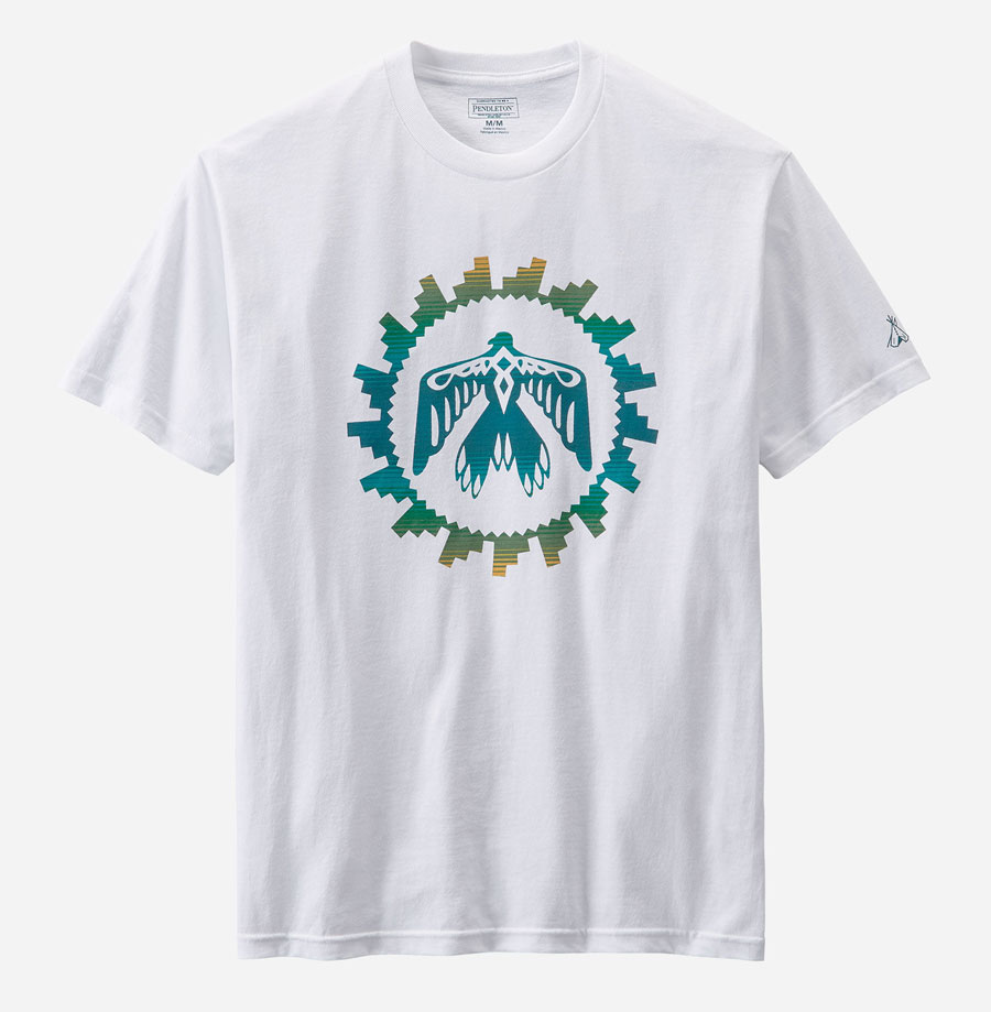 A white t-shirt with a sunrise eagle pattern on the front in blue and green.