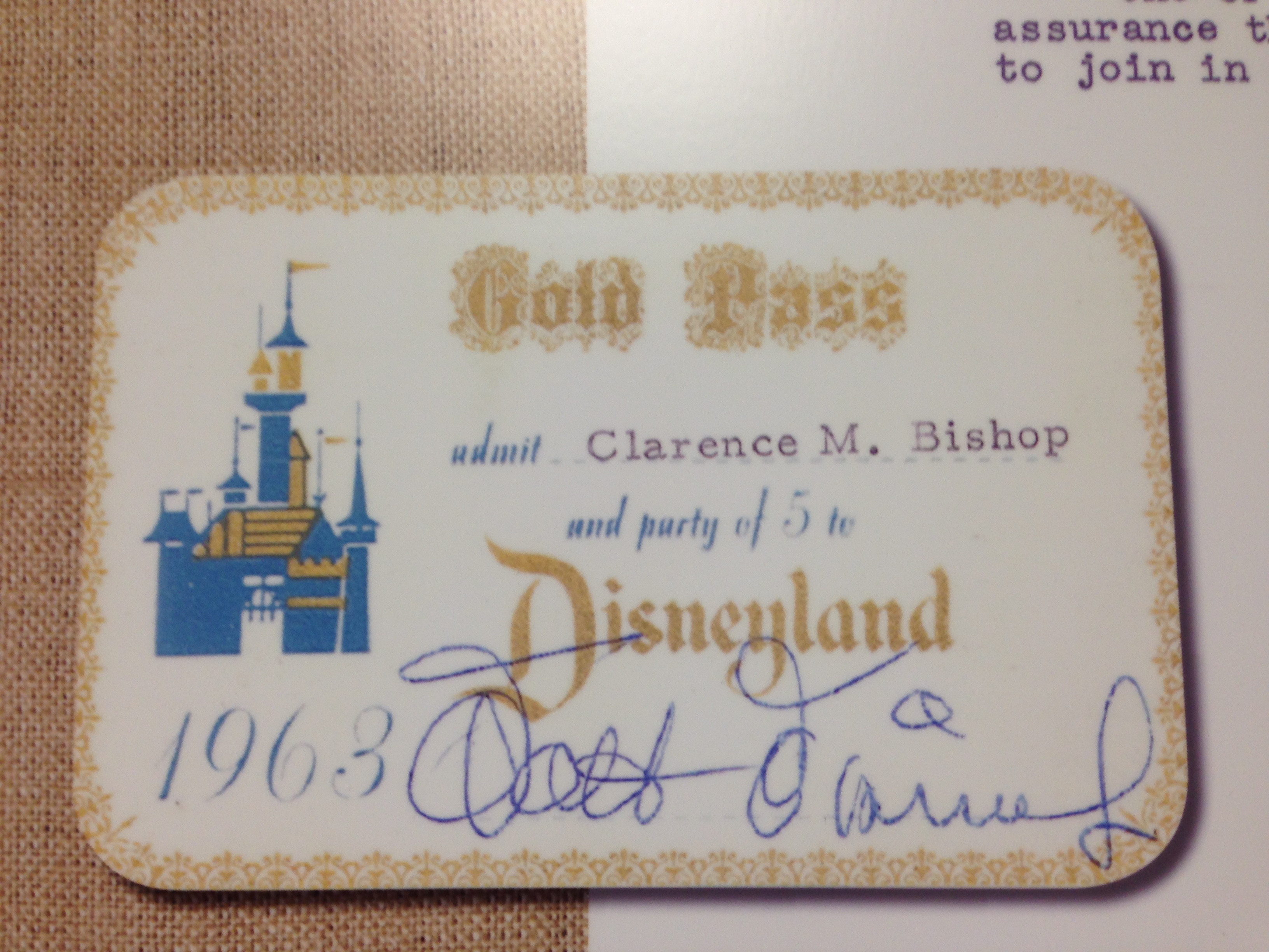 A photo of the 1965 "Gold Pass" issued to Clarence M. Bishop and party of five to Disneyland, signed by Walt Disney himself.