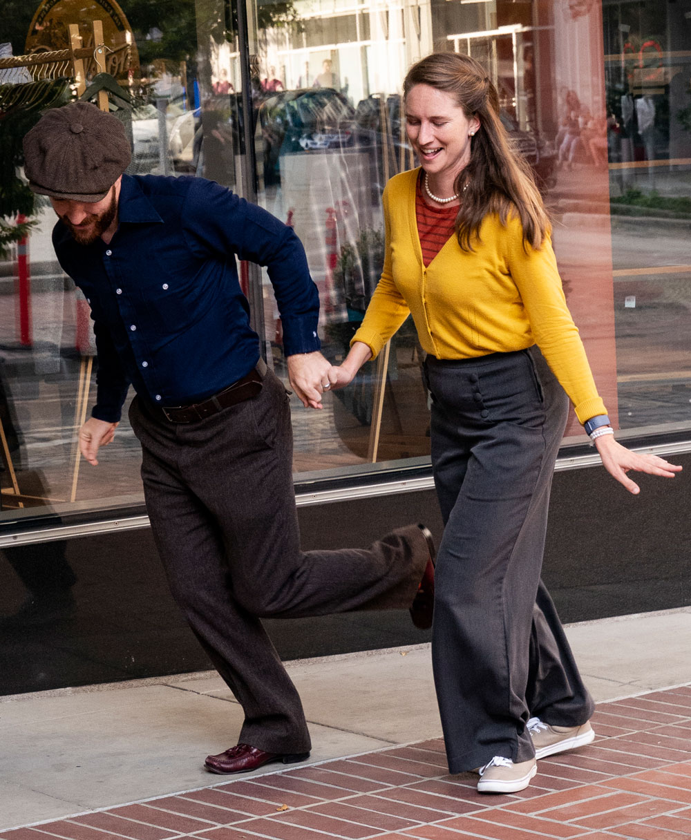 Lindy Hop dancers on sidewalk in front of Pendleton store, dancing, one woman, one man