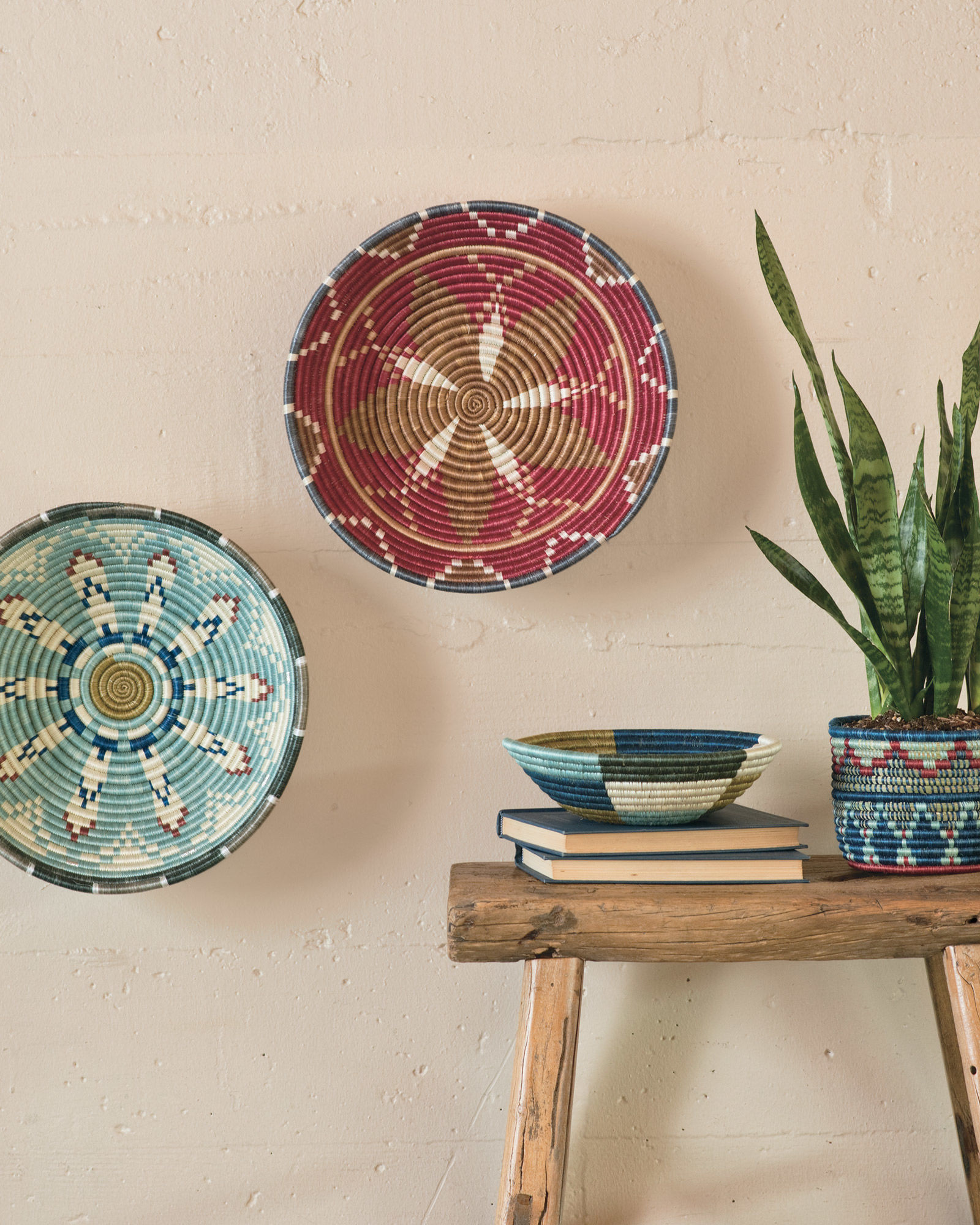 Handmade Rwandan baskets hanging on a wall and on a table