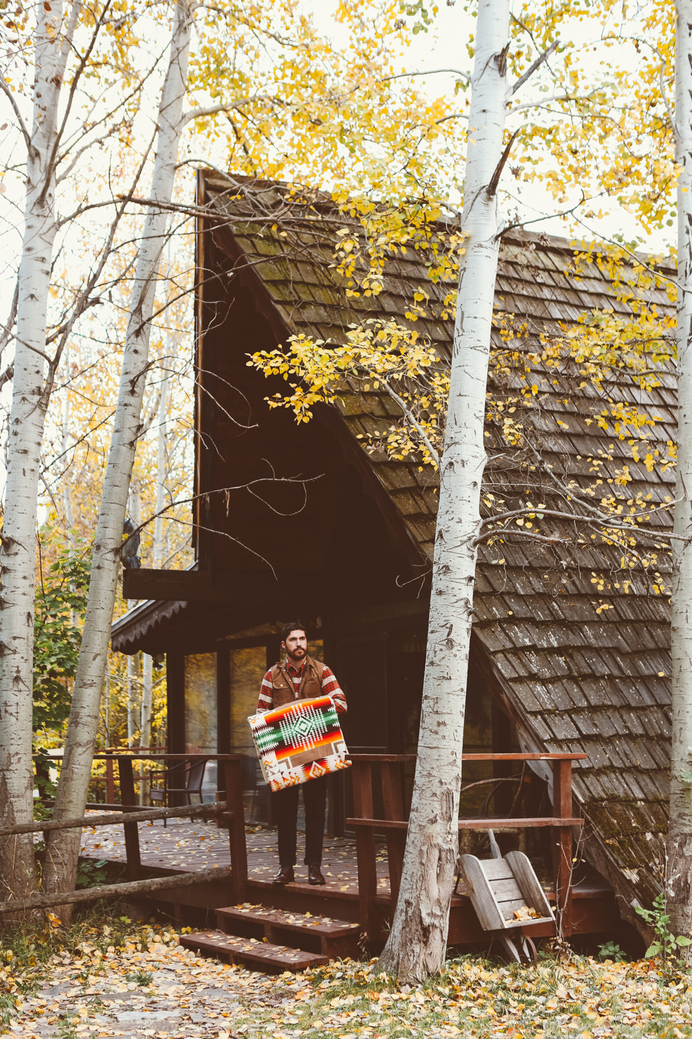 Brandon Burk by an A-frame cabin. 