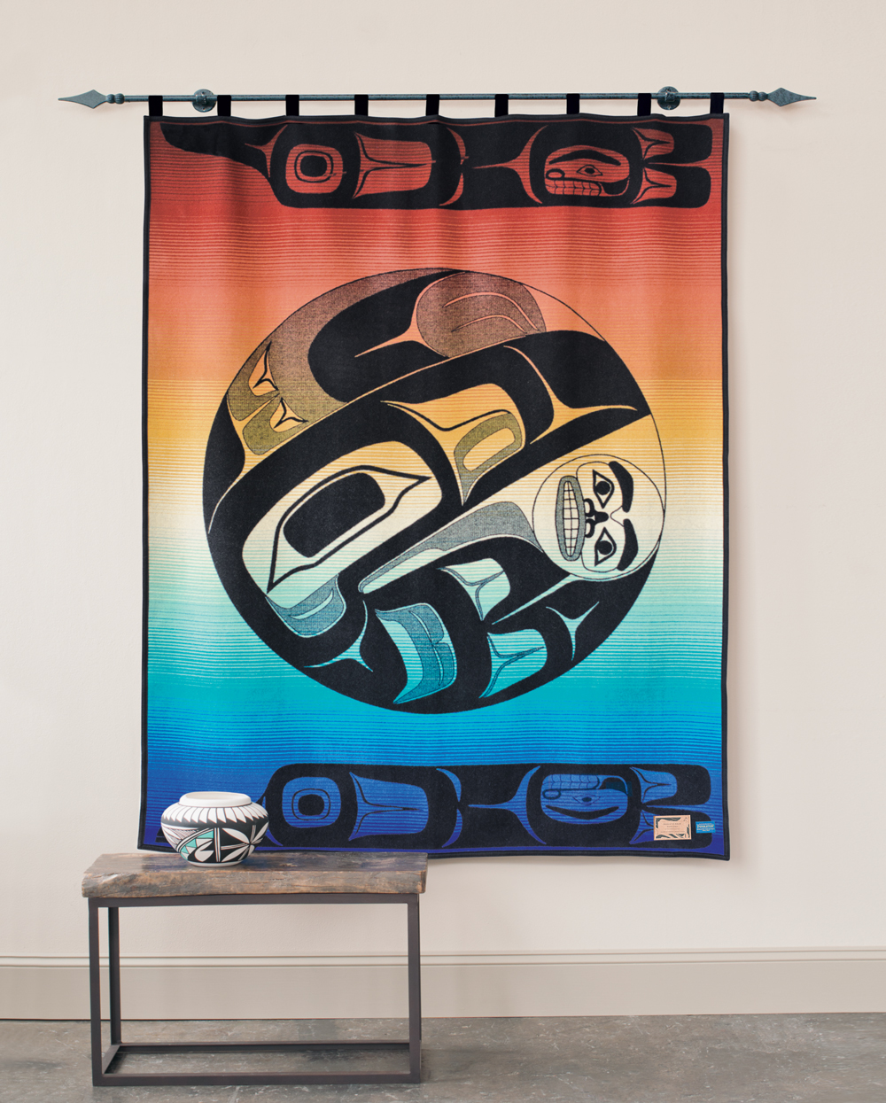 The Pendleton blanket, Raven and the Box of Knowledge, hangs on a wall.