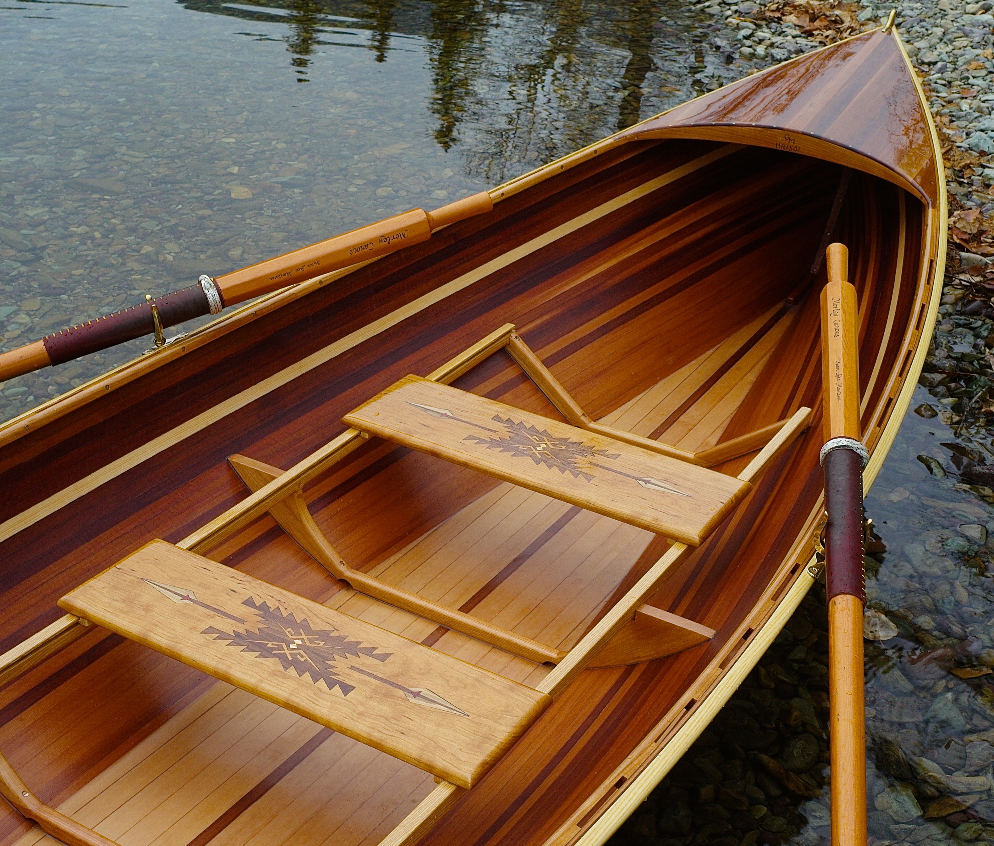 Interior of the canoe, showing Pendleton-inspired patterns inlaid on the benches.