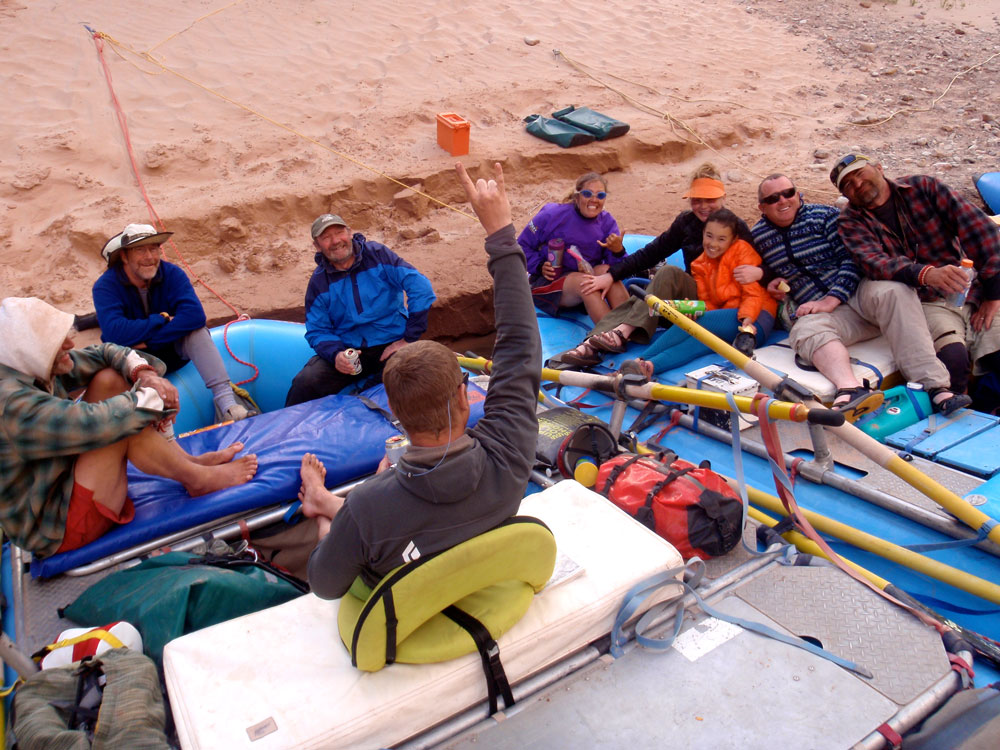 Relaxing at the river's edge: Greg Hatten and eight more river runners relax after a day on the river.