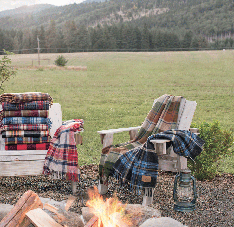 Pendleton motor robes draped on Adirondack wooden chairs.