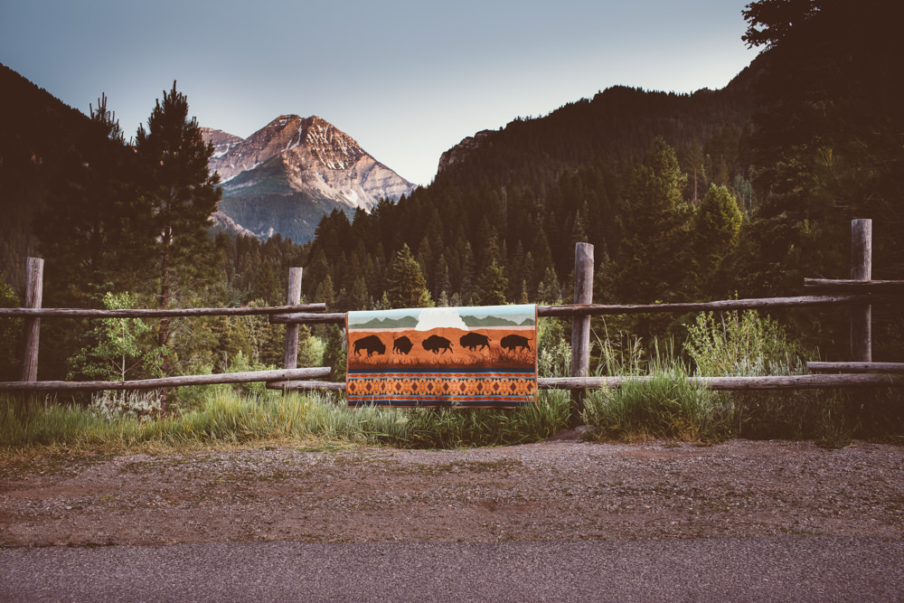 A Yellowstone national park blanket on a wooden rail fence